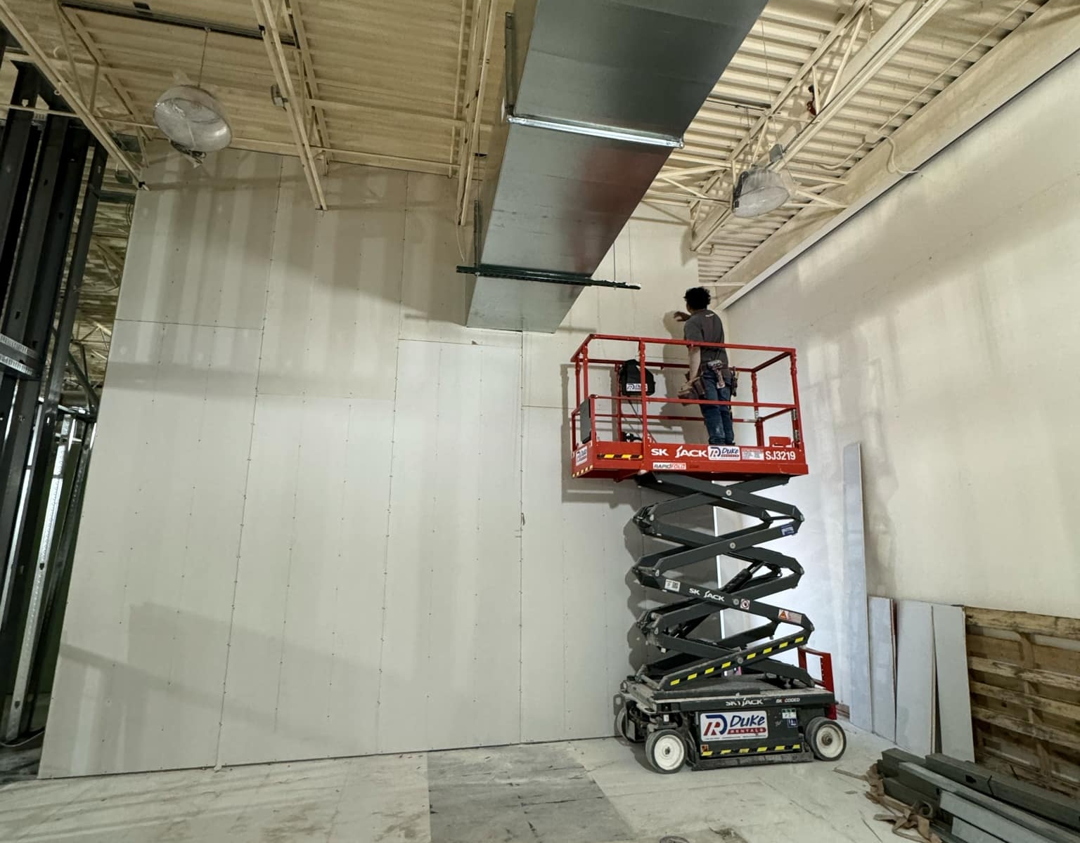 Employee working on drywall